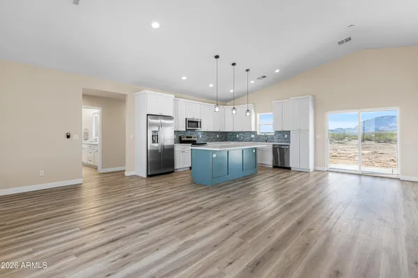 a view of kitchen with wooden floor and electronic appliances