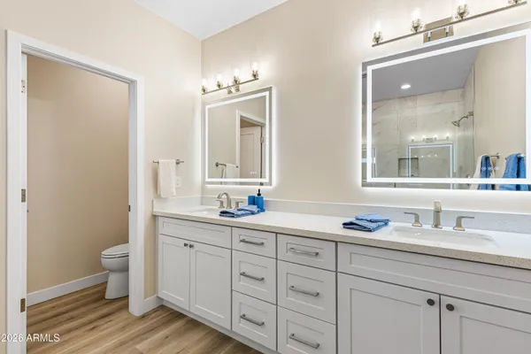 a bathroom with a granite countertop sink mirror and toilet