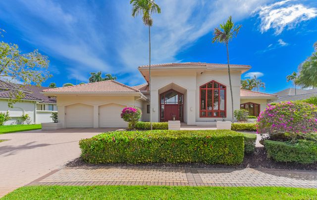 a living room with patio furniture and a floor to ceiling window