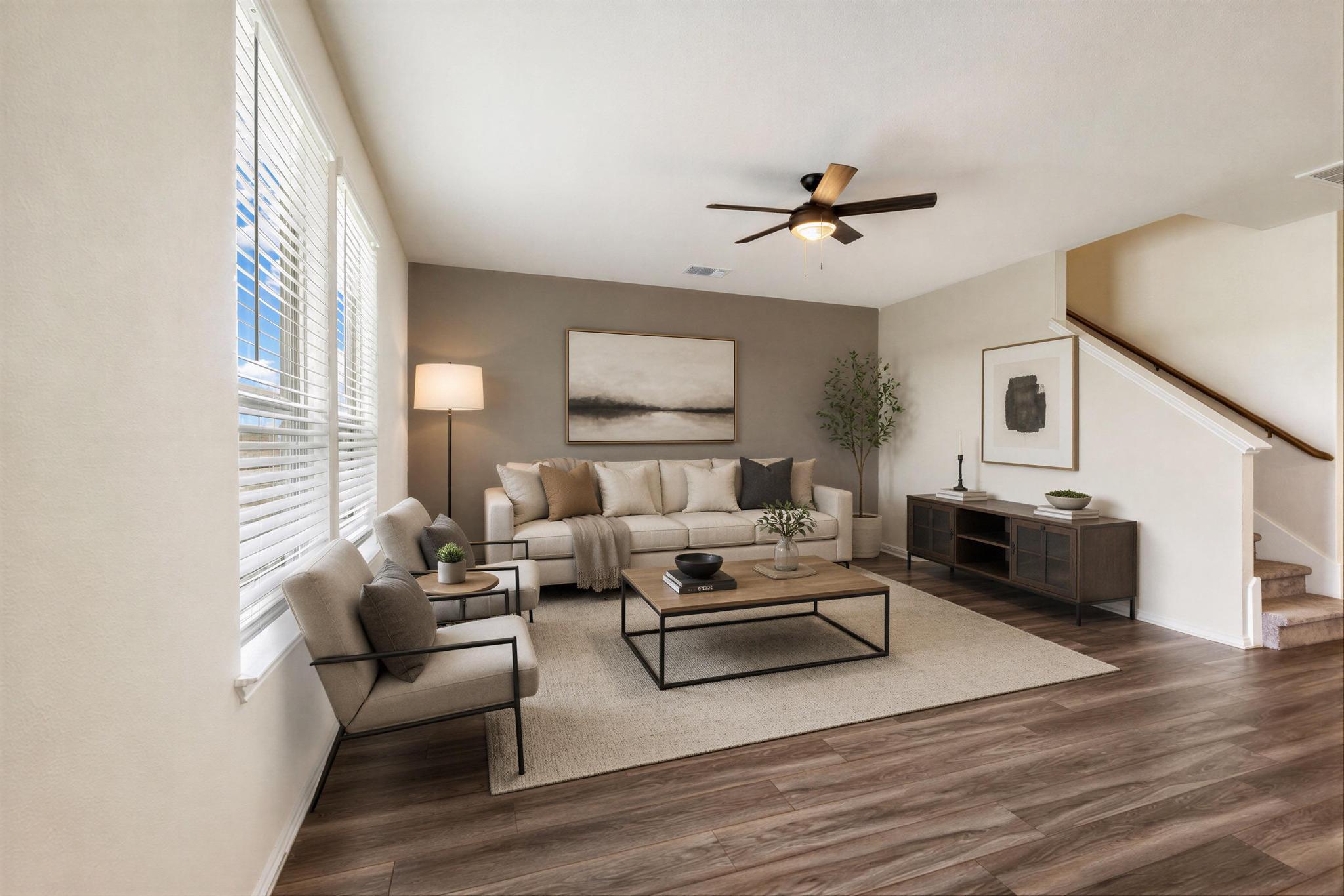 217 Innisfree Road Jarrell, TX 76537 - Photo 11 of 39 Hardwood-style flooring extends through this comfortable living space, centered by a modern ceiling fan. Virtually Staged