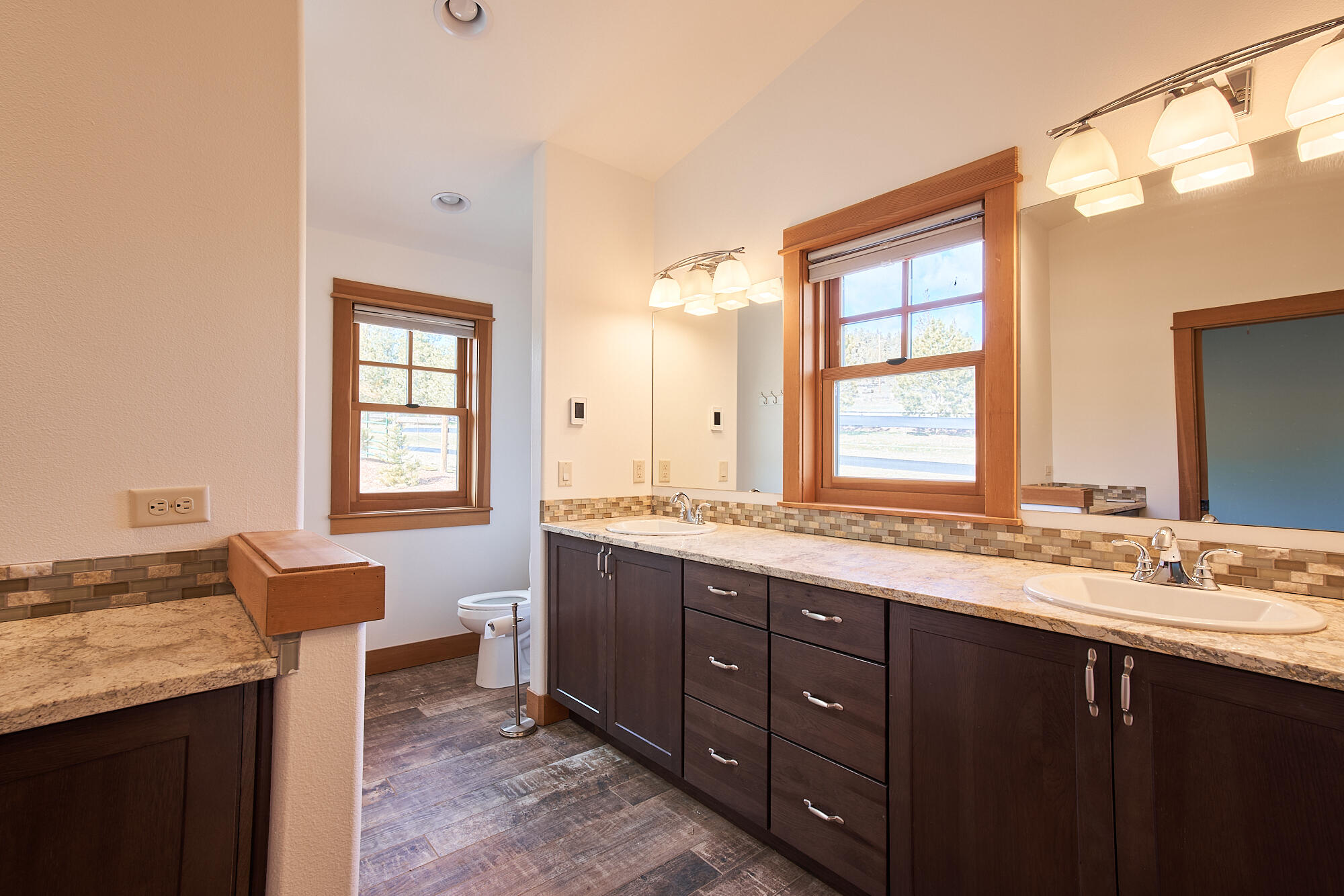 19525 Innes Market Road Bend, OR 97703 - Photo 35 of 56 a spacious bathroom with a granite countertop double vanity and a mirror