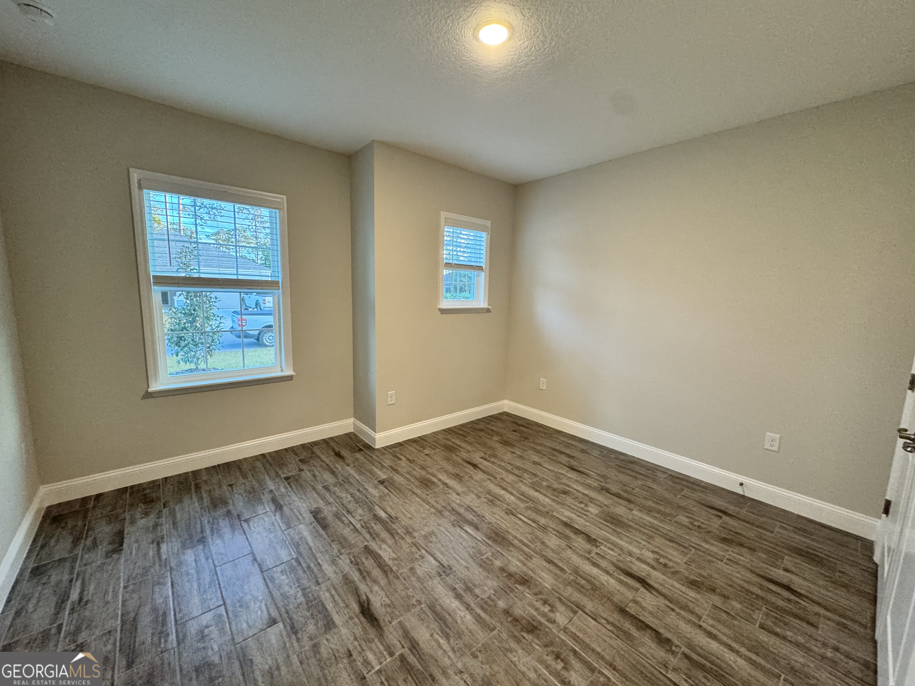 108 Brookshire Grn Court Kingsland, GA 31548 - Photo 14 of 21 wooden floor in an empty room with a window