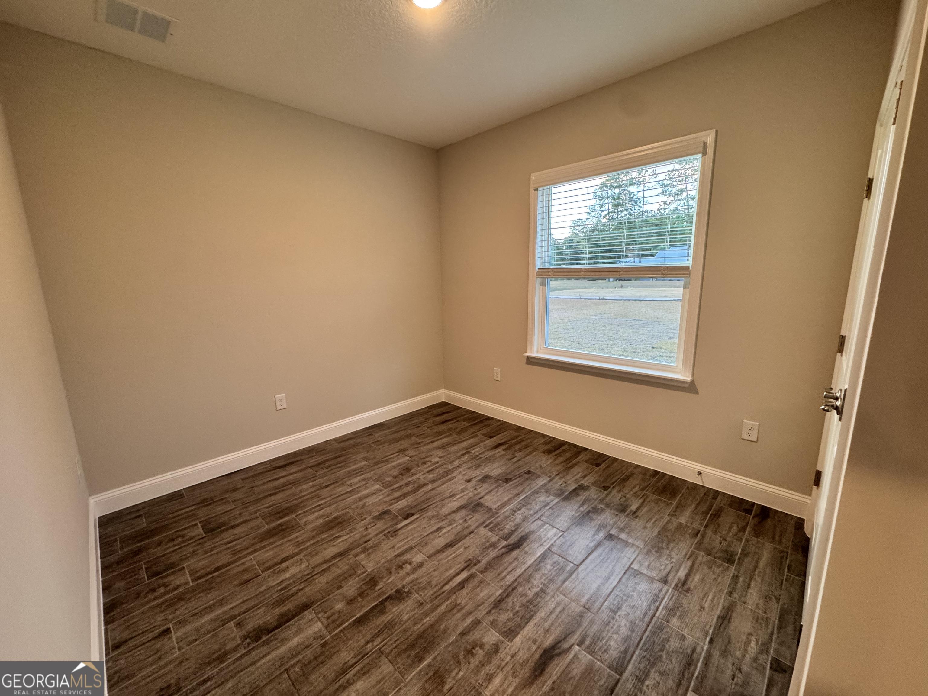 108 Brookshire Grn Court Kingsland, GA 31548 - Photo 16 of 21 an empty room with wooden floor and windows