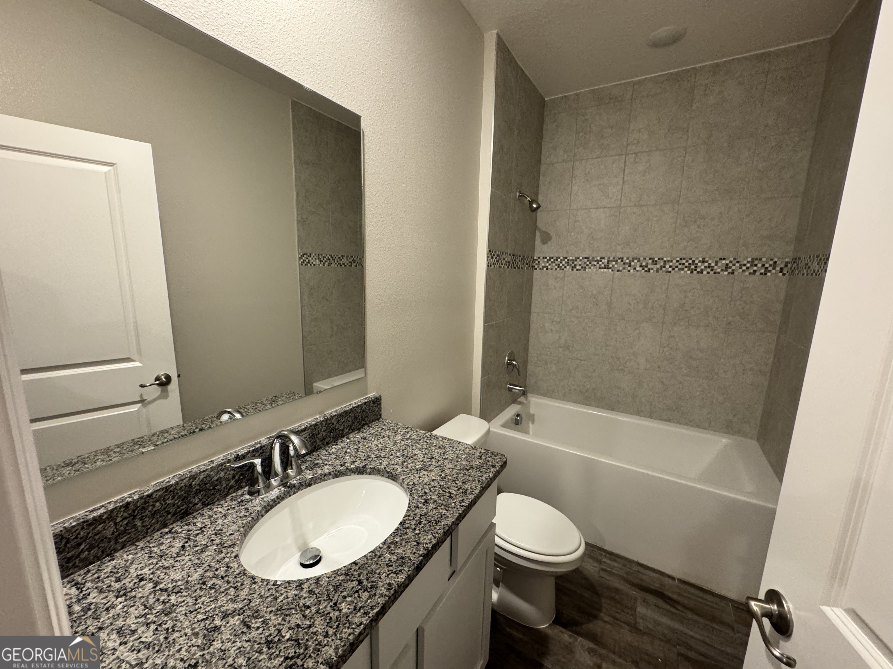 108 Brookshire Grn Court Kingsland, GA 31548 - Photo 17 of 21 a bathroom with a granite countertop sink toilet mirror and bathtub