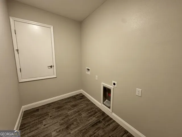 a view of a room with wooden floor and bathroom