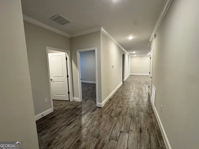 a view of hallway with wooden floor