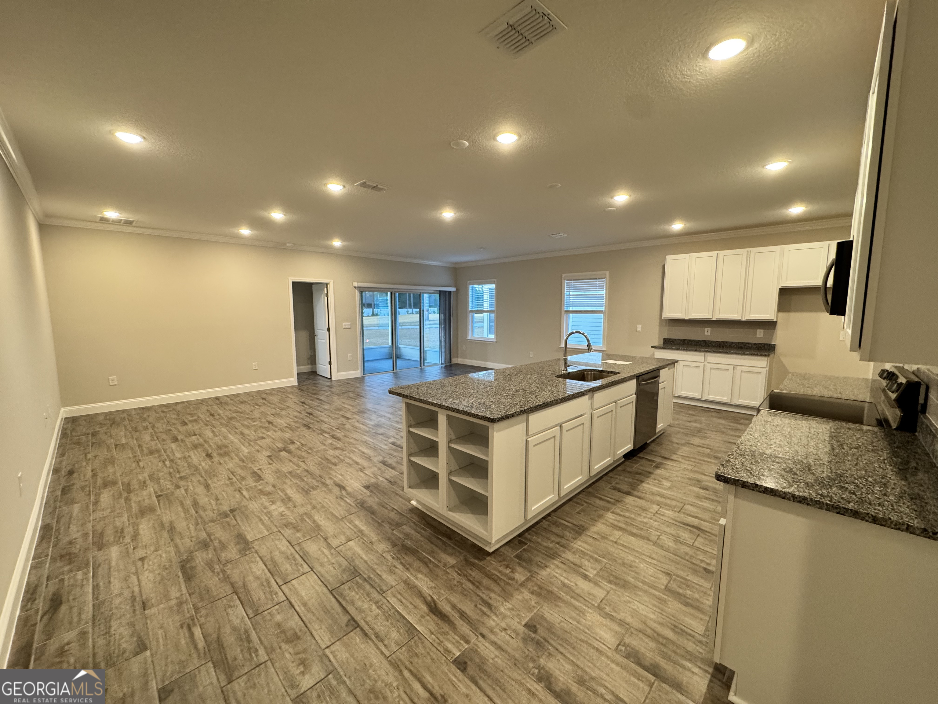 108 Brookshire Grn Court Kingsland, GA 31548 - Photo 4 of 21 a large kitchen with stainless steel appliances a large counter top a stove a sink and a refrigerator