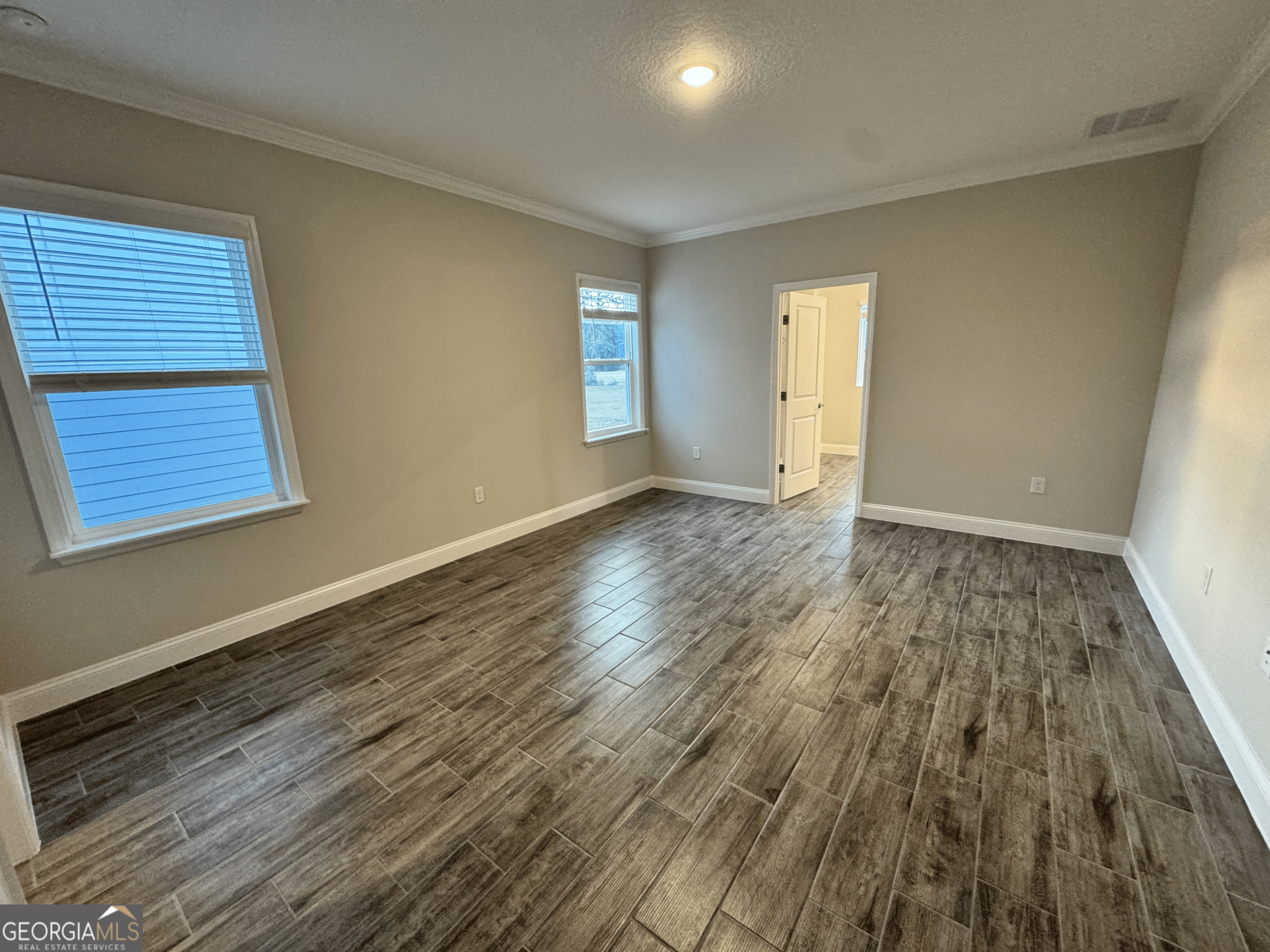 108 Brookshire Grn Court Kingsland, GA 31548 - Photo 10 of 21 an empty room with wooden floor and windows