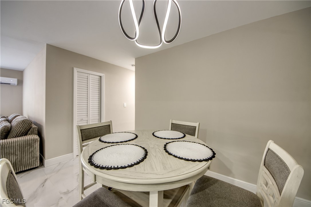 2544 First Street, Unit 107 Fort Myers, FL 33901 - Photo 15 of 35 a dining room with furniture and a chandelier