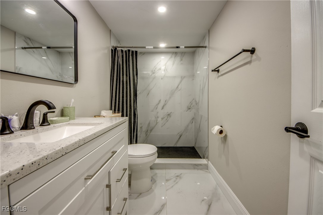 2544 First Street, Unit 107 Fort Myers, FL 33901 - Photo 30 of 35 a bathroom with a sink a toilet and shower