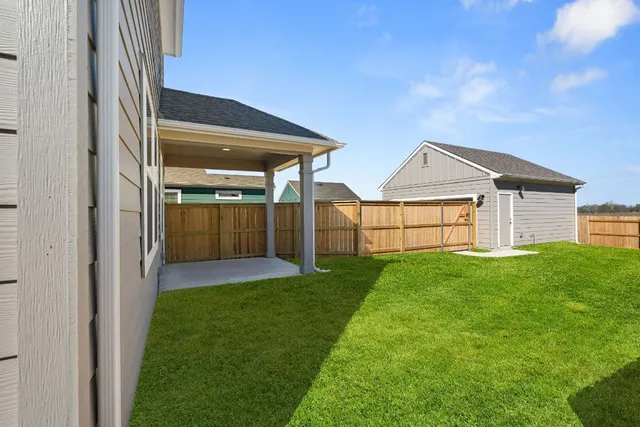 a view of an empty room with wooden floor and closet