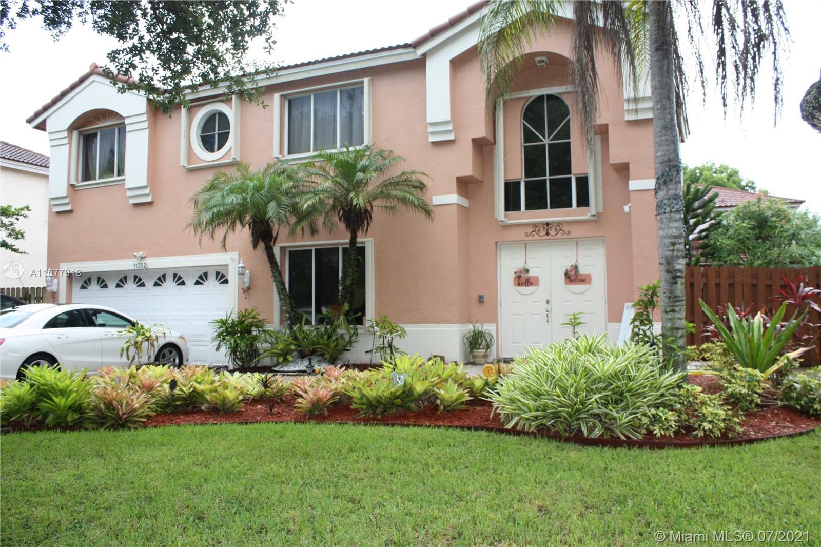 11352 Roundelay Road Cooper City, FL 33026 - Photo 2 of 30 a front view of a house with a garden