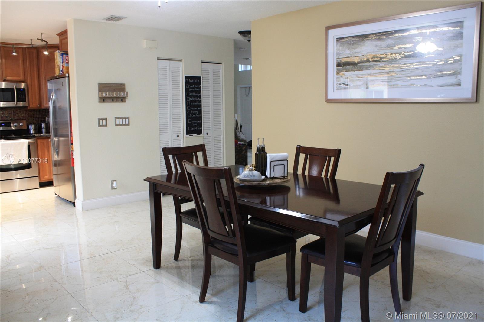 11352 Roundelay Road Cooper City, FL 33026 - Photo 12 of 30 a view of a dining room with furniture