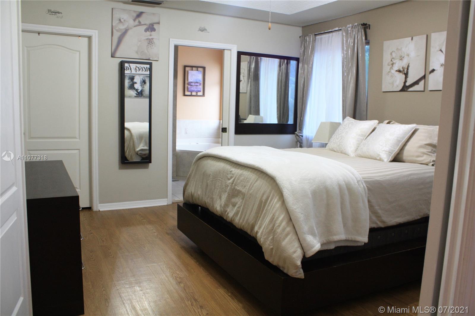 11352 Roundelay Road Cooper City, FL 33026 - Photo 15 of 30 a bed sitting in a bedroom next to a window