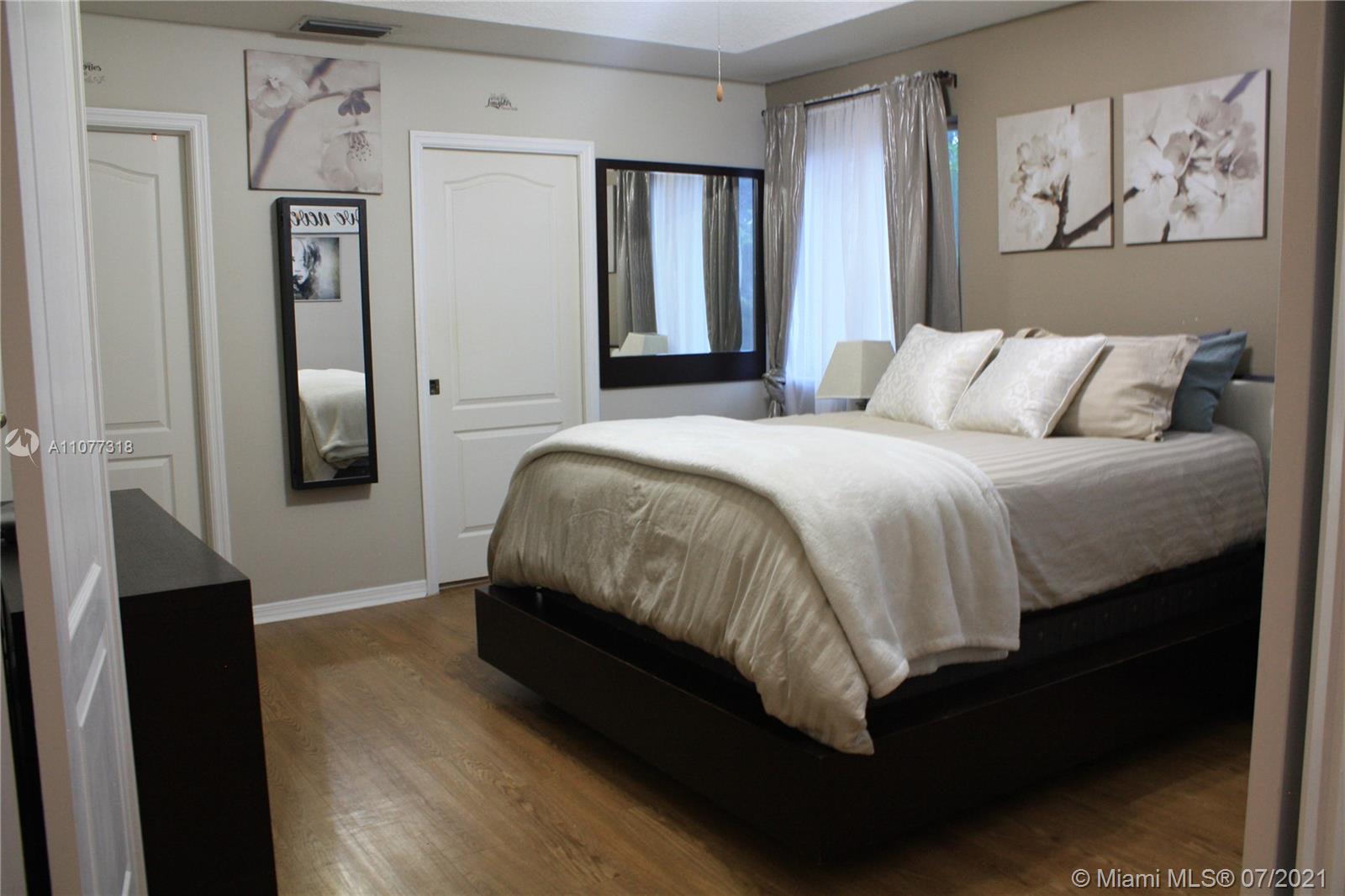 11352 Roundelay Road Cooper City, FL 33026 - Photo 17 of 30 a bedroom with a bed and wall painting