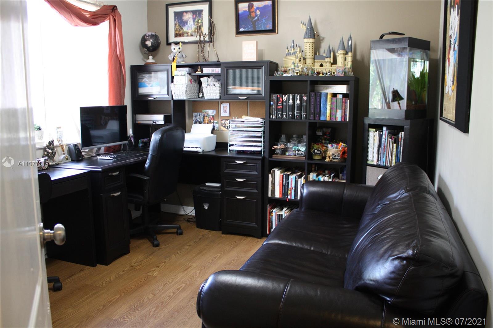 11352 Roundelay Road Cooper City, FL 33026 - Photo 20 of 30 a living room with furniture and a flat screen tv