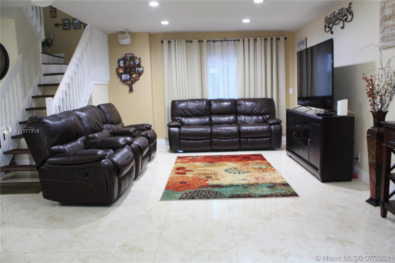 11352 Roundelay Road Cooper City, FL 33026 - Photo 3 of 30 a living room with furniture and a rug