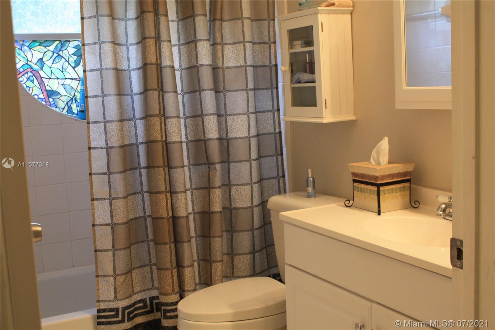 11352 Roundelay Road Cooper City, FL 33026 - Photo 21 of 30 a bathroom with a sink toilet and shower