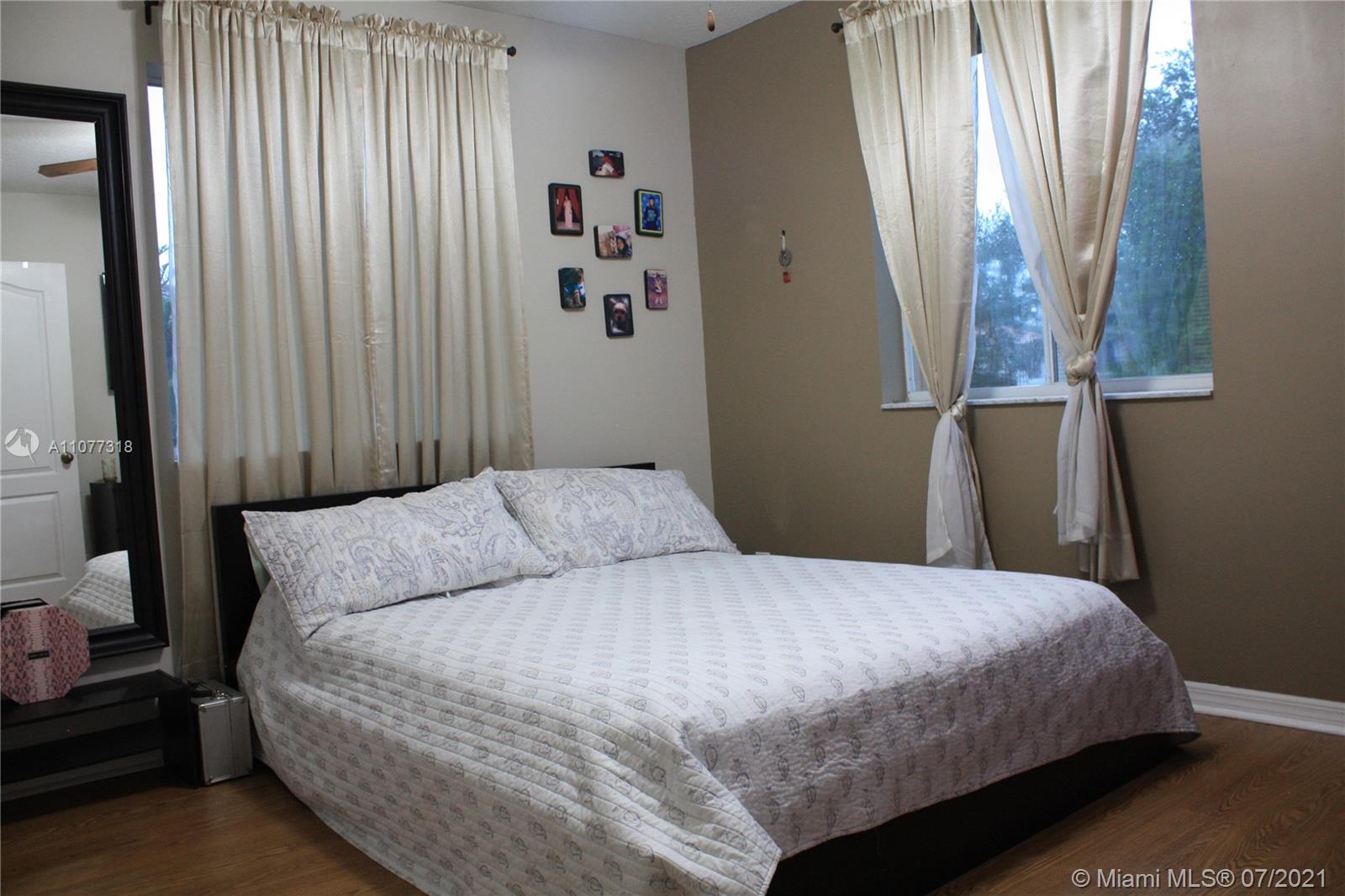 11352 Roundelay Road Cooper City, FL 33026 - Photo 22 of 30 a bedroom with a bed and a window