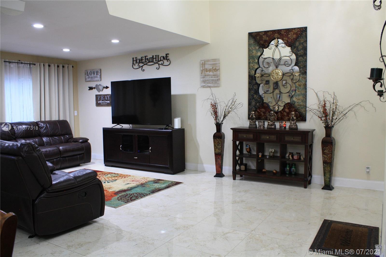 11352 Roundelay Road Cooper City, FL 33026 - Photo 5 of 30 a living room with furniture and a flat screen tv