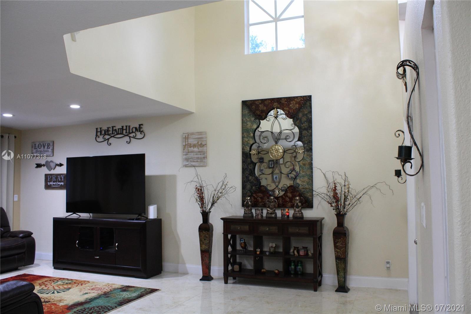 11352 Roundelay Road Cooper City, FL 33026 - Photo 6 of 30 a living room with furniture and a flat screen tv