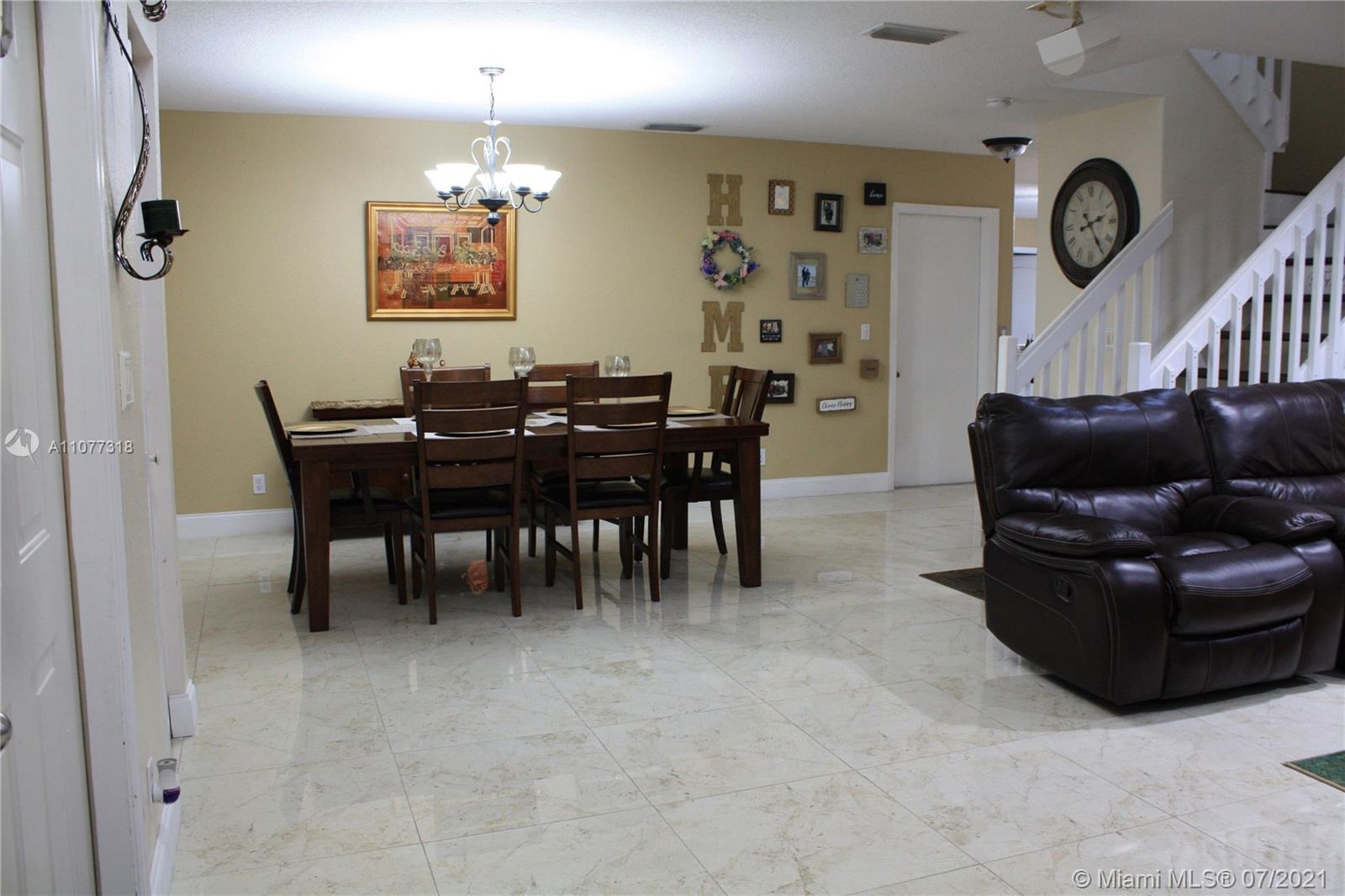 11352 Roundelay Road Cooper City, FL 33026 - Photo 9 of 30 a living room with furniture a clock and a window