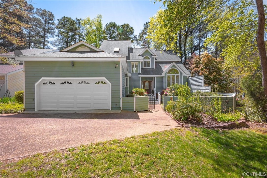 14324 Regatta Pointe Road Midlothian, VA 23112 - Photo 3 of 50 a front view of a house with a yard and garage