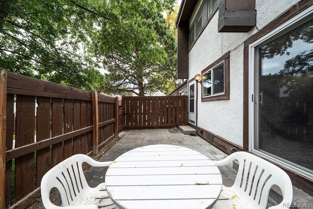112 Scotland Road, Unit F Pueblo, CO 81001 - Photo 11 of 39 a view of a deck with wooden floor and fence