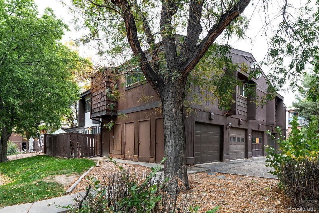 112 Scotland Road, Unit F Pueblo, CO 81001 - Photo 13 of 39 front view of a house with a large trees