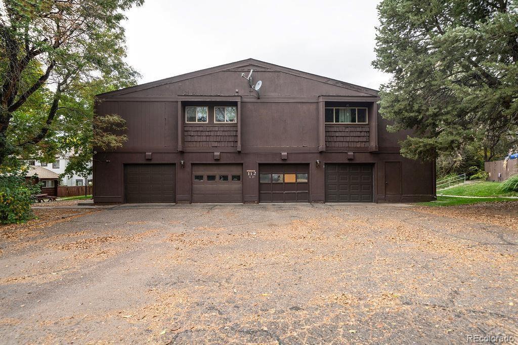 112 Scotland Road, Unit F Pueblo, CO 81001 - Photo 15 of 39 a front view of a house with a yard and garage