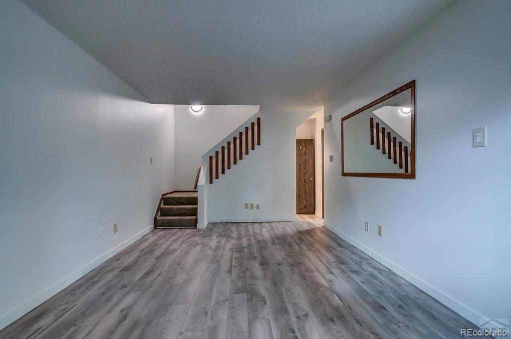 112 Scotland Road, Unit F Pueblo, CO 81001 - Photo 17 of 39 a view of an empty room with stairs and a window