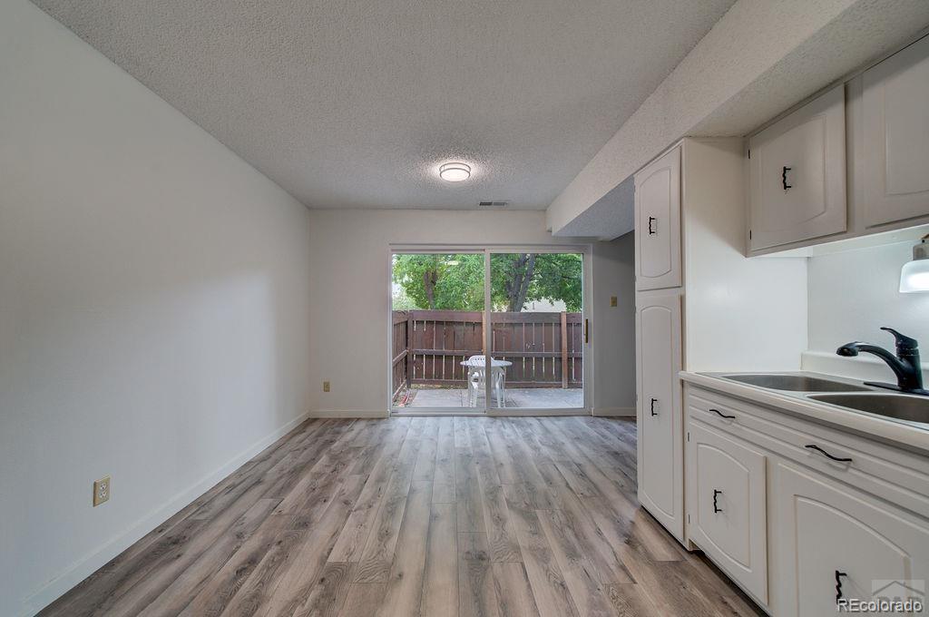 112 Scotland Road, Unit F Pueblo, CO 81001 - Photo 19 of 39 a living room with stainless steel appliances granite countertop a stove a sink and a large window