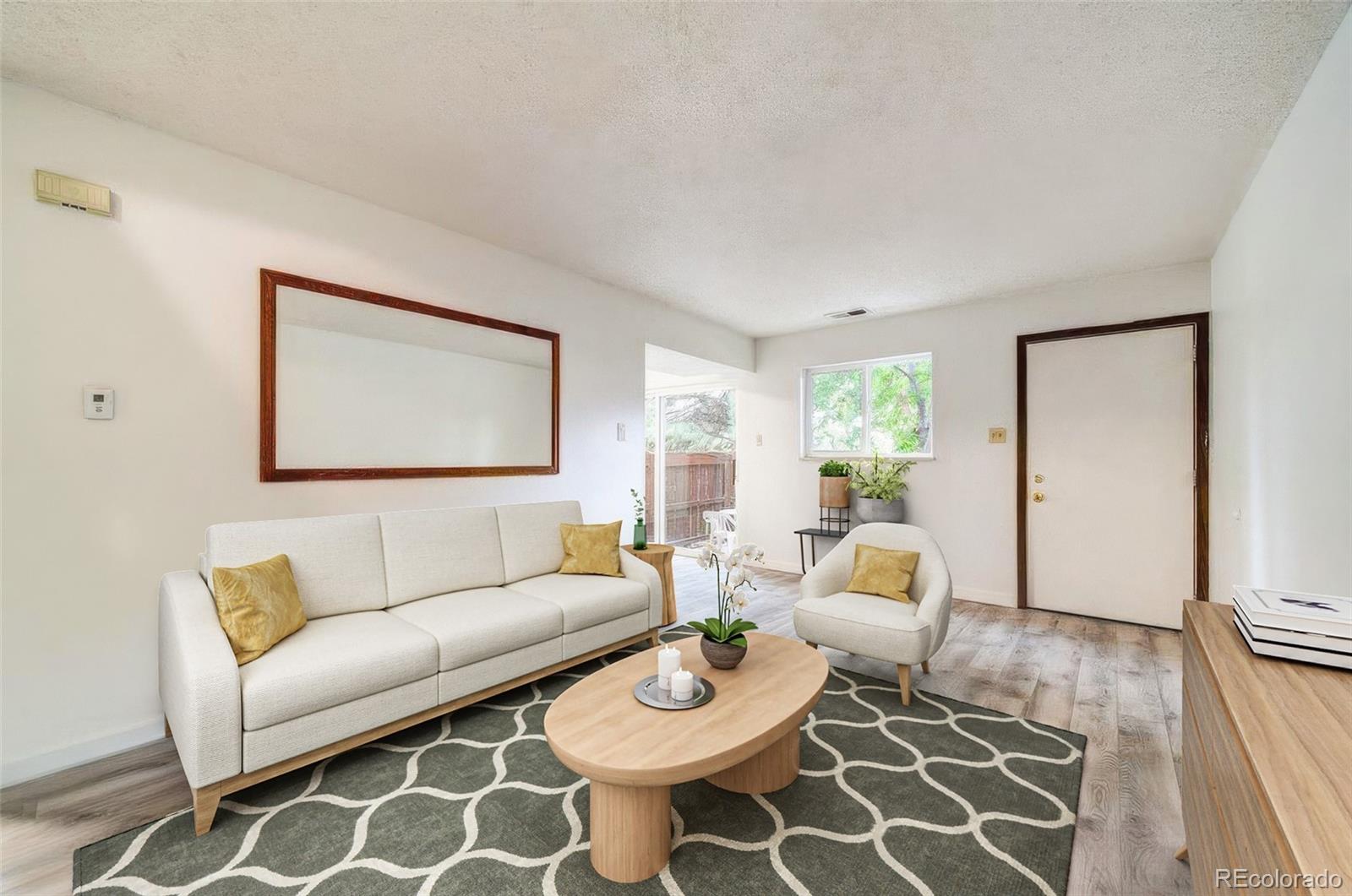 112 Scotland Road, Unit F Pueblo, CO 81001 - Photo 2 of 39 a living room with furniture and wooden floor