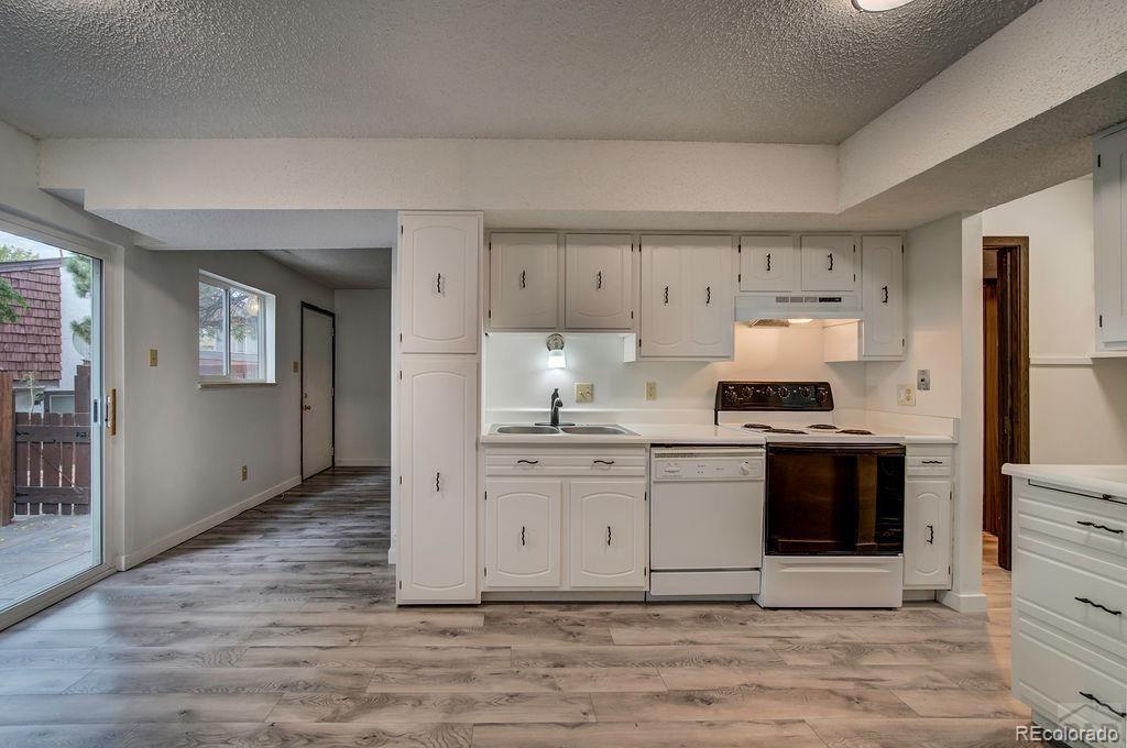 112 Scotland Road, Unit F Pueblo, CO 81001 - Photo 21 of 39 a kitchen with stainless steel appliances white cabinets and stove top oven
