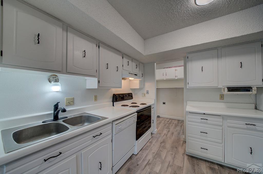 112 Scotland Road, Unit F Pueblo, CO 81001 - Photo 23 of 39 a kitchen with cabinets appliances a sink and a counter top