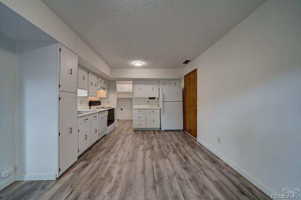 112 Scotland Road, Unit F Pueblo, CO 81001 - Photo 24 of 39 a view of a kitchen with wooden floor