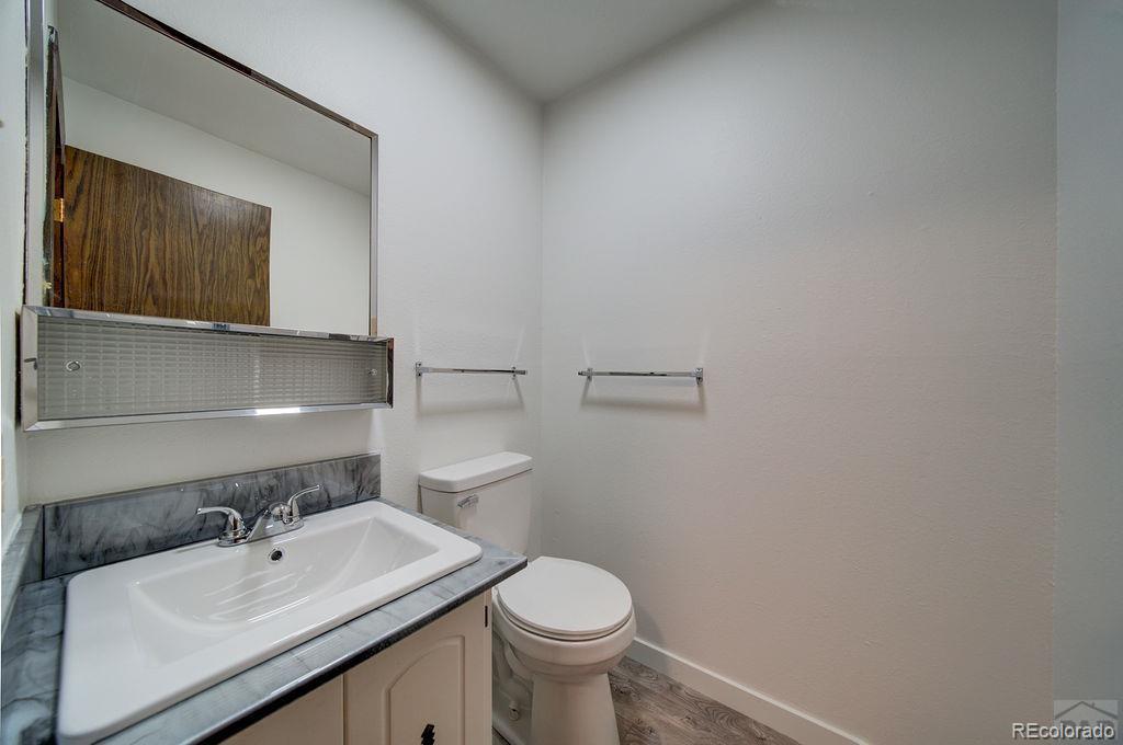 112 Scotland Road, Unit F Pueblo, CO 81001 - Photo 27 of 39 a bathroom with a sink toilet and mirror
