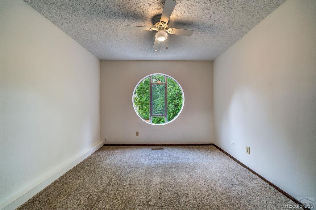 112 Scotland Road, Unit F Pueblo, CO 81001 - Photo 29 of 39 an empty room with a window and a fan