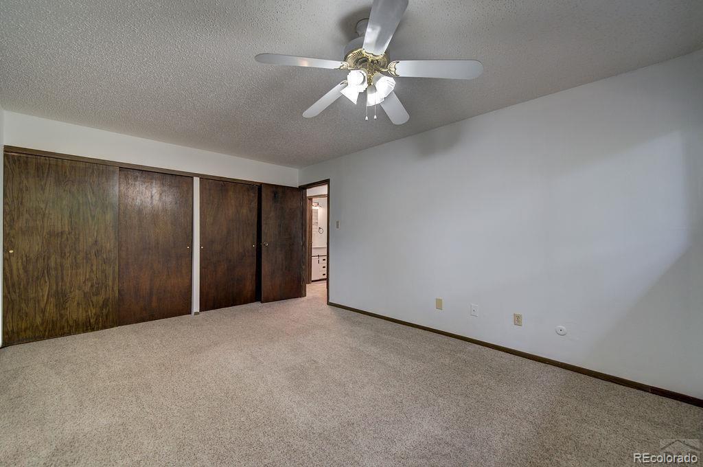 112 Scotland Road, Unit F Pueblo, CO 81001 - Photo 31 of 39 a view of an empty room with a chandelier fan