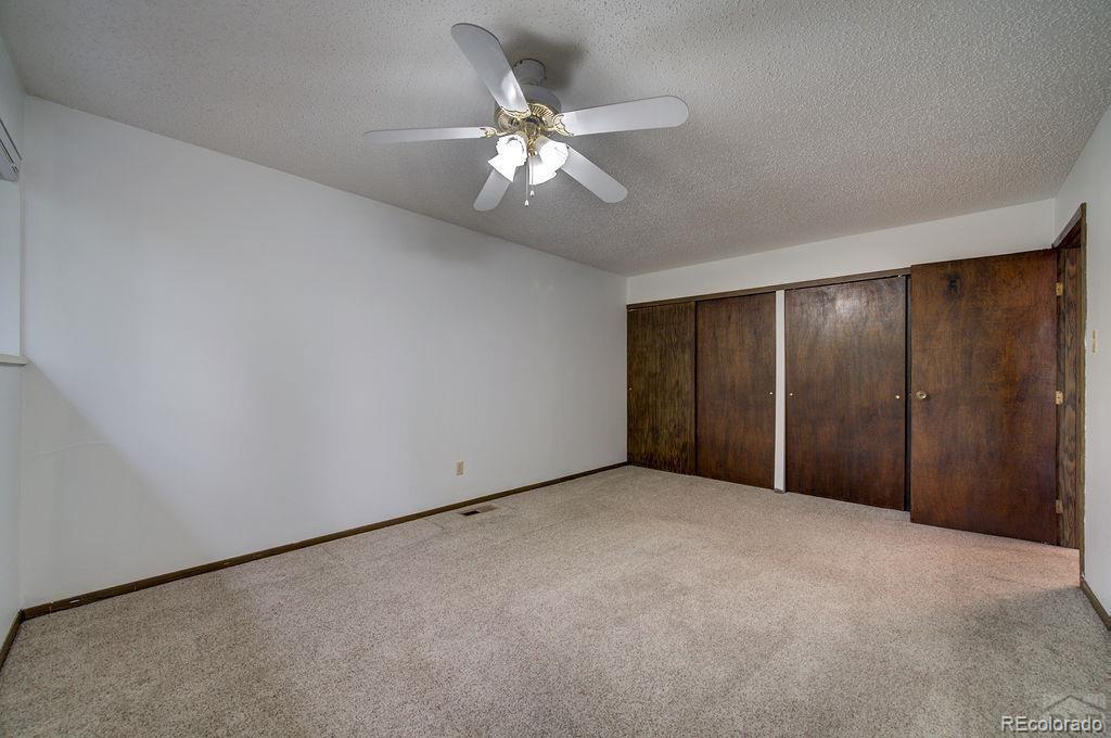 112 Scotland Road, Unit F Pueblo, CO 81001 - Photo 32 of 39 a view of an empty room with a ceiling fan and window