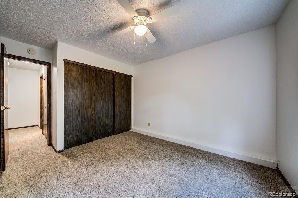 112 Scotland Road, Unit F Pueblo, CO 81001 - Photo 35 of 39 an empty room with closet and a ceiling fan