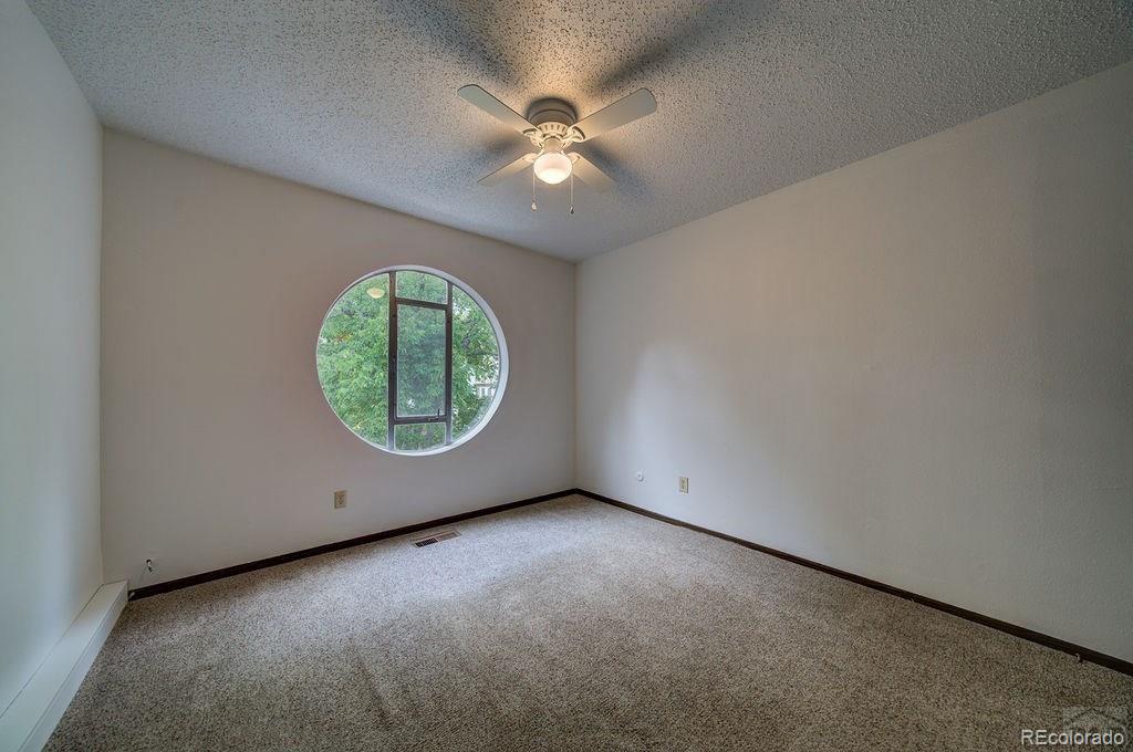 112 Scotland Road, Unit F Pueblo, CO 81001 - Photo 9 of 39 an empty room with a fan and a window
