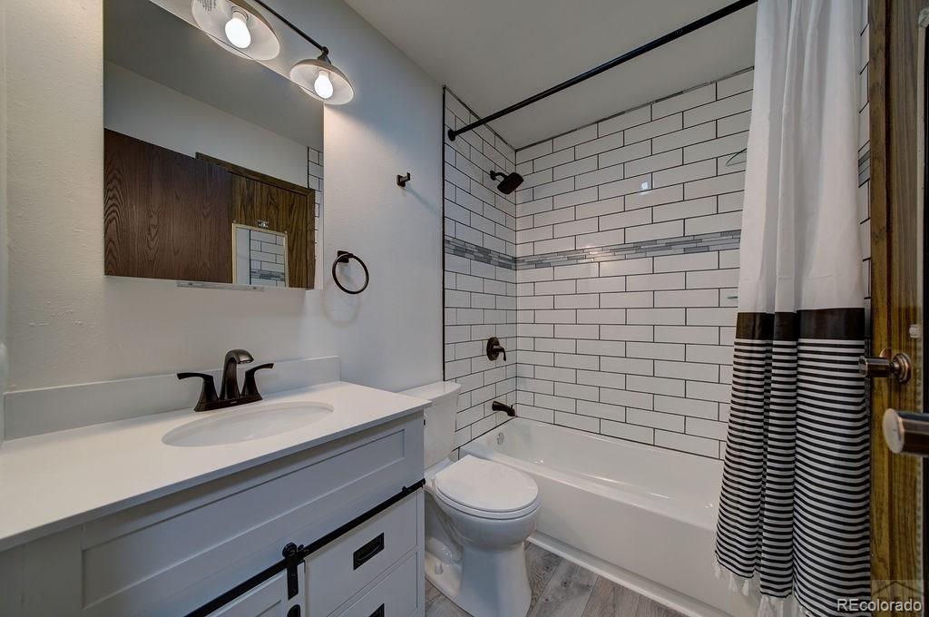 112 Scotland Road, Unit F Pueblo, CO 81001 - Photo 10 of 39 a bathroom with a sink a toilet and shower