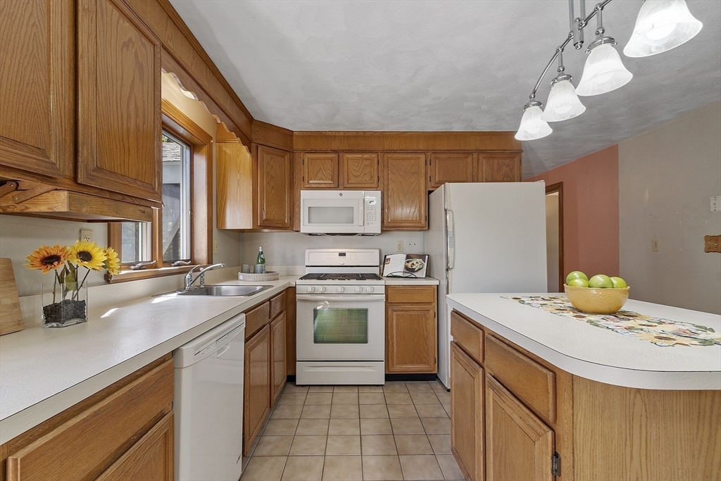 120 Concord Road Billerica, MA 01821 - Photo 12 of 42 a kitchen with a sink a stove cabinets and a refrigerator
