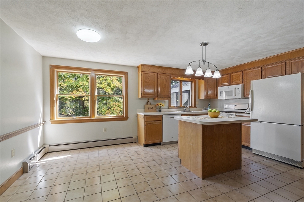 120 Concord Road Billerica, MA 01821 - Photo 13 of 42 a kitchen with a refrigerator and a stove