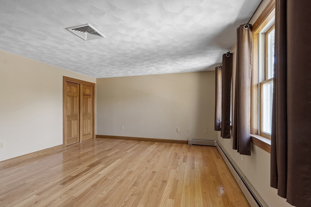 120 Concord Road Billerica, MA 01821 - Photo 26 of 42 an empty room with wooden floor and a window