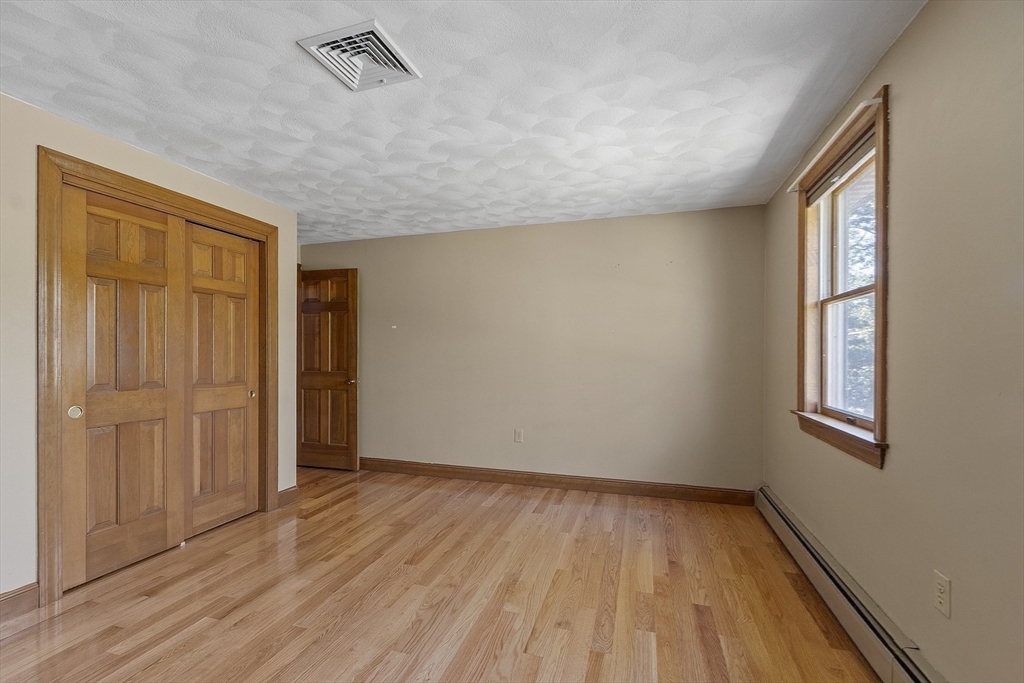 120 Concord Road Billerica, MA 01821 - Photo 30 of 42 an empty room with wooden floor and windows