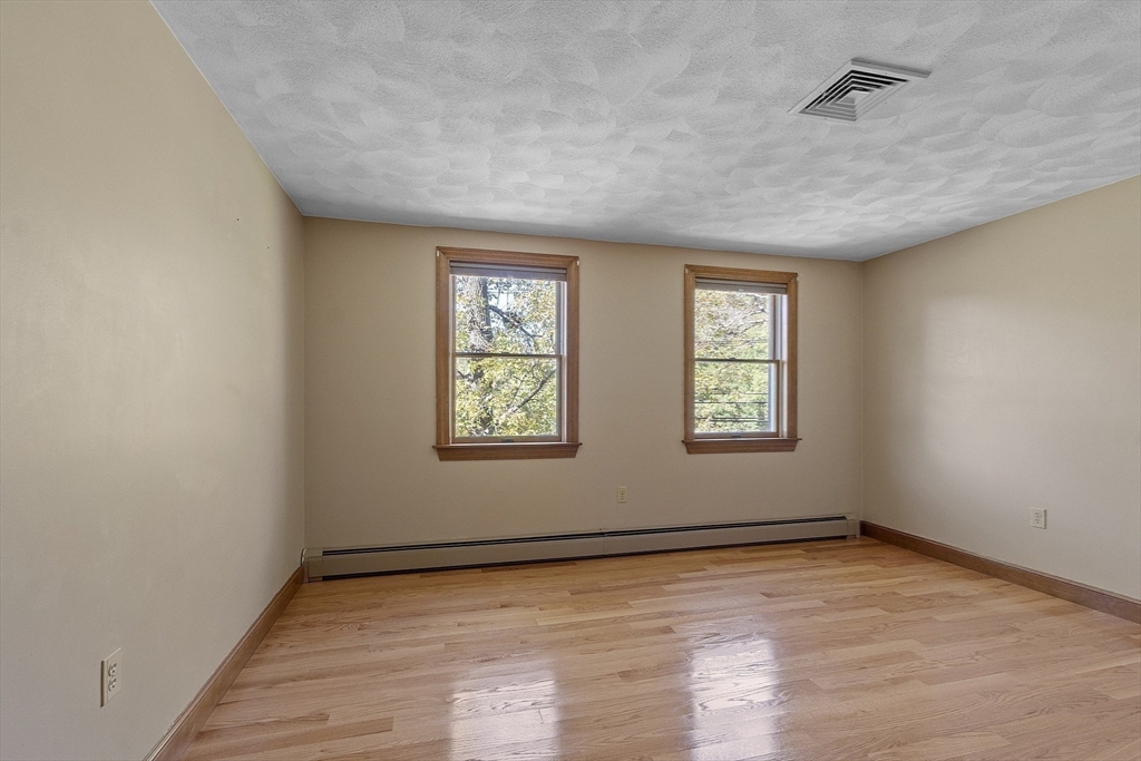 120 Concord Road Billerica, MA 01821 - Photo 31 of 42 an empty room with wooden floor and windows