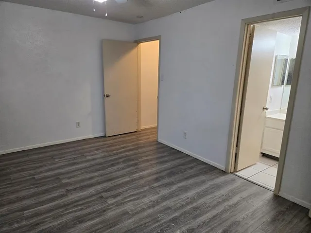 a view of a room with wooden floor and a window