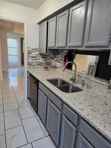 a kitchen with a sink and cabinets